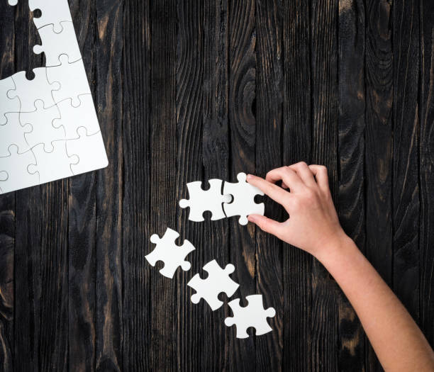 istock hand starting to collect puzzle pieces 1510867615