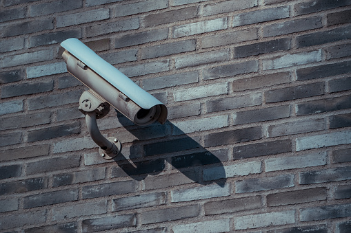 Security camera on brick wall