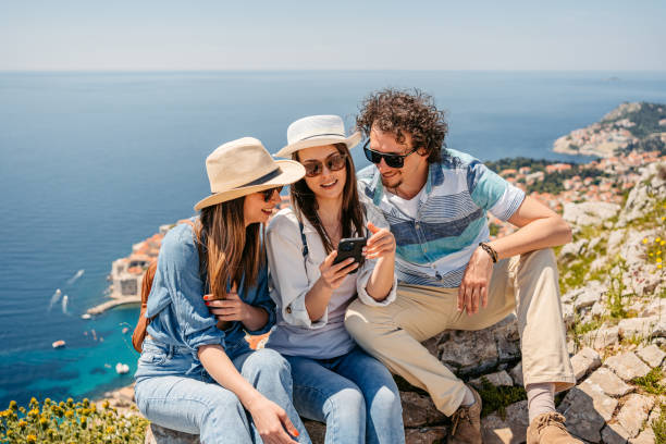 istock Three Friends Using Phone At A High Viewpoint Of Dubrovnik 1510903164