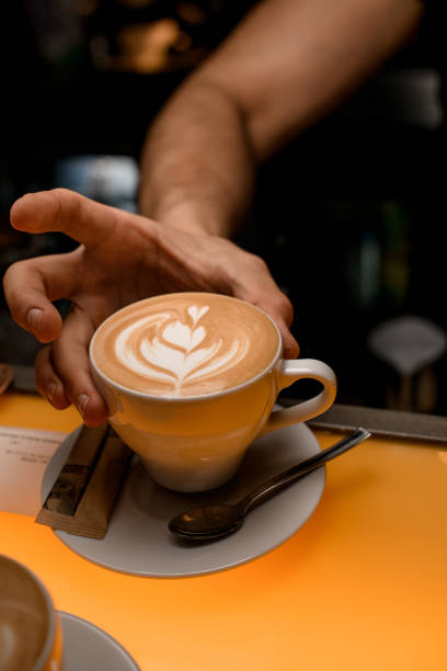 istock Barman hands holding fresh coffee in white cup at restaurant, bar or pub 1510903724