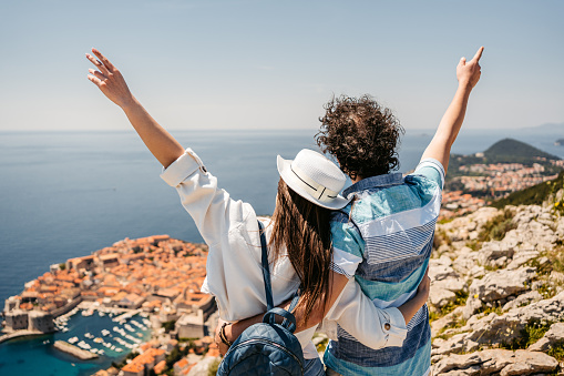 Young tourist couple enjoying the view of Dubrovnik from a high viewpoint in Croatia.