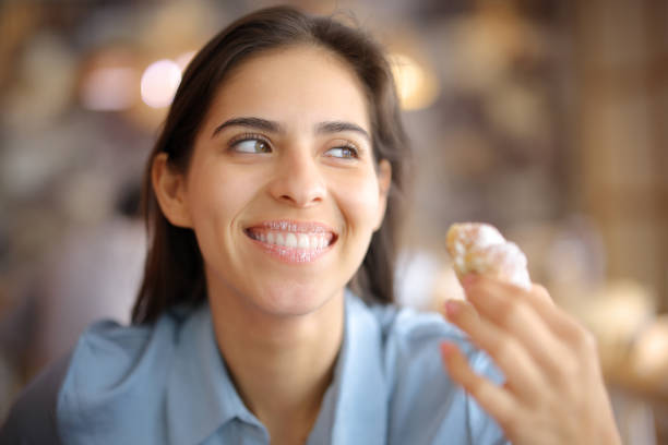 Restaurant customer eating croissant with dirty lips