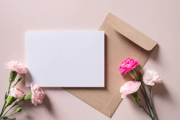 istock White blank greeting or invitation card and envelope with flowers decoration on pink background. Mock up presentation. 1510958840