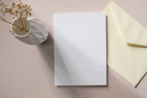 istock White blank greeting or invitation card and envelope with ceramic jar decoration on white background. 1510959402
