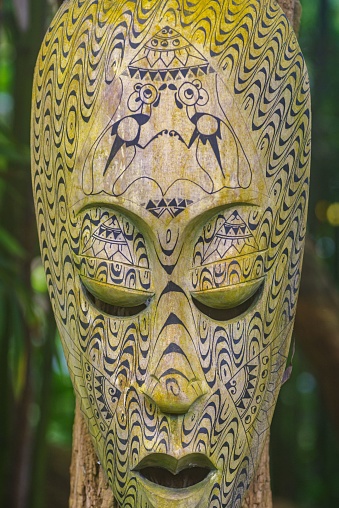 A close-up of an African voodoo mask on a blurred background