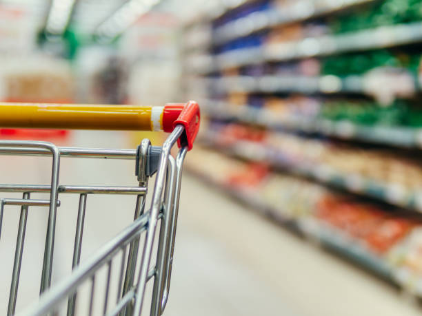 istock shopping trolley in supermarket aisle, copy space 1510973669