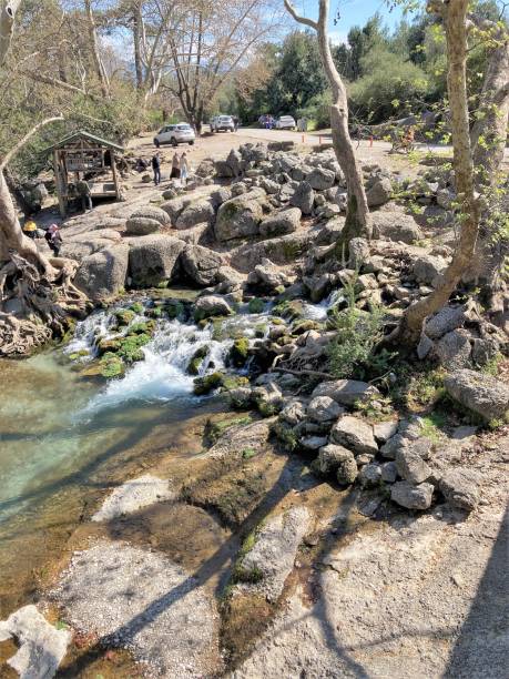 istock The stream of water flows through large stones and forms a small waterfall 1510974180