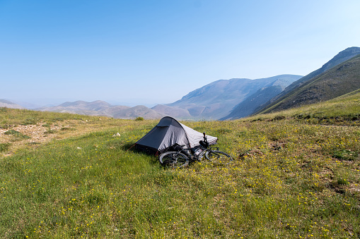 Mediterranean region mountains at high altitudes. Tent camping. Open air. Green areas plateau. Landscape camping photo