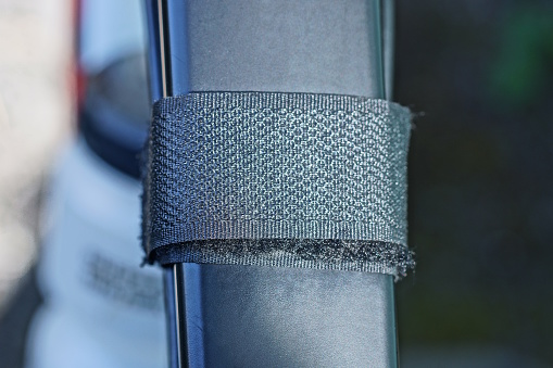 part of one black metal pipe with Velcro fabric fasteners outside
