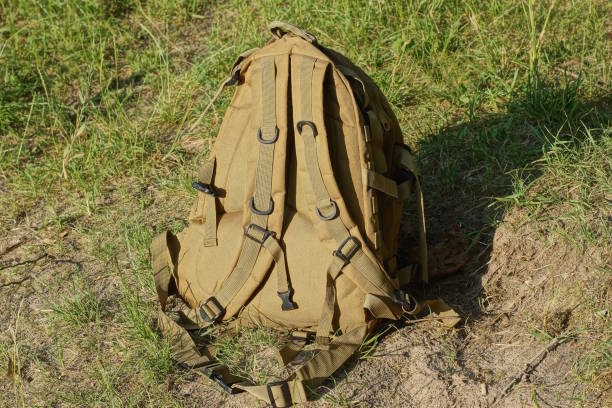 istock one brown army backpack stands on gray ground 1511003188