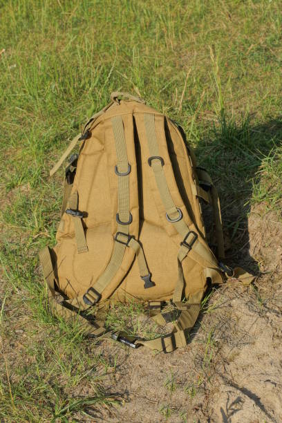 istock one brown army backpack stands on gray ground 1511003190