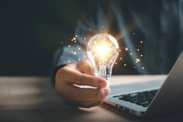 istock Businessman protects a glowing light bulb, symbolizing creativity and innovation 1511026688