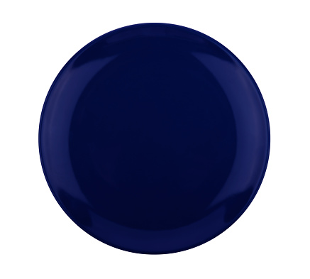 Dark blue ceramic plate isolated on white background. Top view
