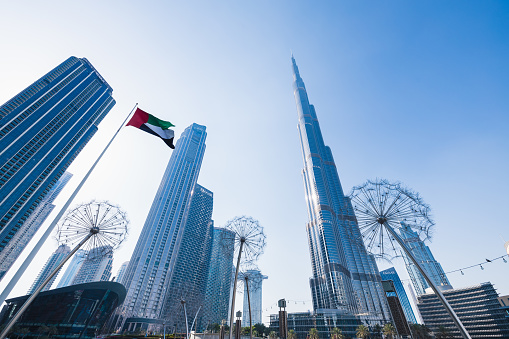 Dubai, United Arab Emirates - June 30 2023: Burj Khalifa Dubai. Beautiful shot of Burj Khalifa with UAE flag flying in the foreground.