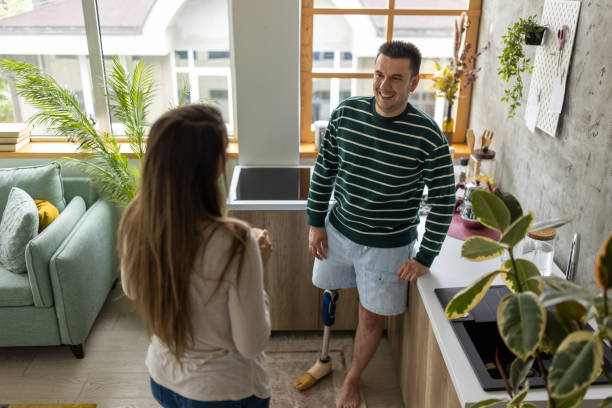 istock Young disabled man talking to his friend at home 1511066376