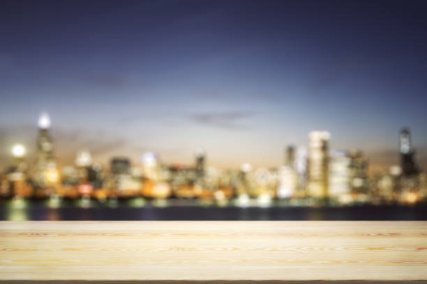 istock Blank wooden table top with beautiful blurry skyline at night on background, mockup 1511072350