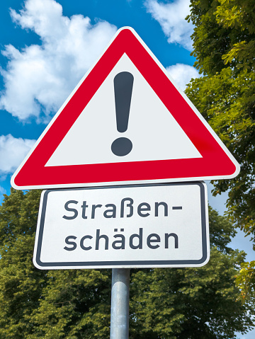 Triangle traffic warning sign - road damage
