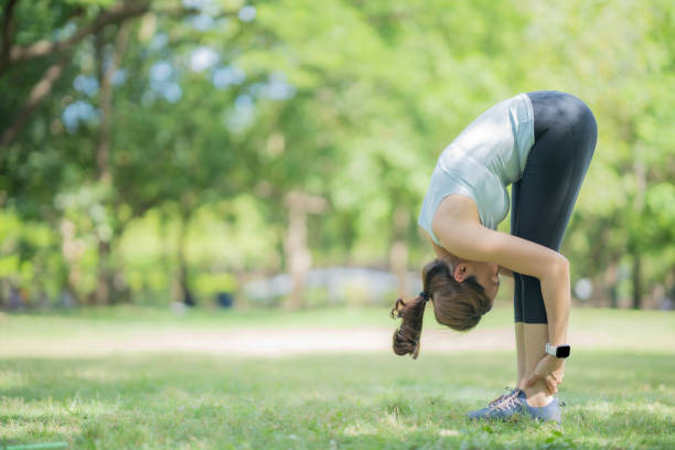 istock Asian woman do stretching before do yoga at park, using smart watch technology tracking her activity. 1511098544
