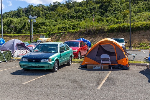 yauco, Puerto Rico – January 15, 2020: An outdoor parking lot filled with parked cars, colorful tents