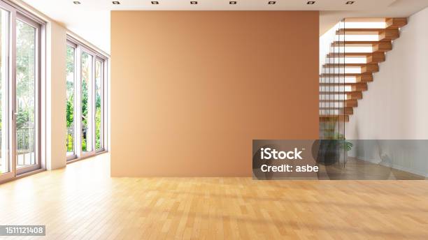 Unfurnished Living Room With Empty Beige Wall And Stairs Stock Photo - Download Image Now