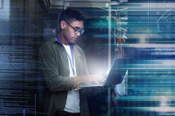 istock Server room, laptop and man with date overlay for cyber security, programming and writing software code. Technician person or geek in data center for motherboard or firewall system assessment at work 1511130057