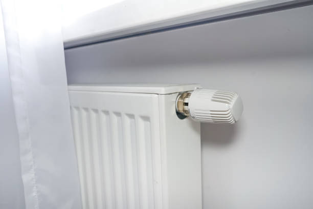 istock Radiator at home. White radiator with temperature adjuster. 1511130155