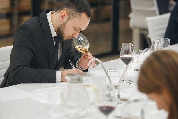 istock Young man sommelier tasting white wine during study in wine school. Alcoholic beverages degustation. Professional occupation. 1511140410