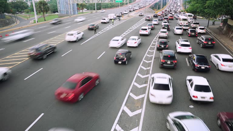 Cinematic time lapse of many cars and trucks driving fast by the road marking asphalt on multi lane speed highway. Blur motion city traffic background