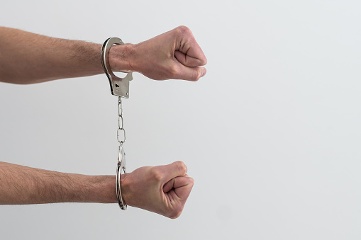 Man's Hands In Handcuffs. criminal.
