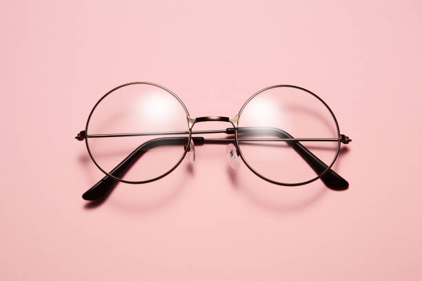 istock Glasses in round thin metal frame isolated on pink surface. 1511151049