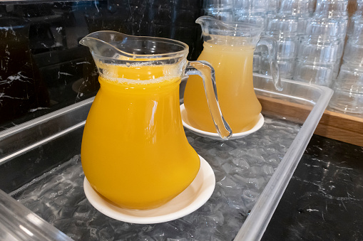 Close-up of pouring water to transparent glass. Bubbles in sparkling water. Homemade lemonade, source of vitamins, healthy lifestyle concept.