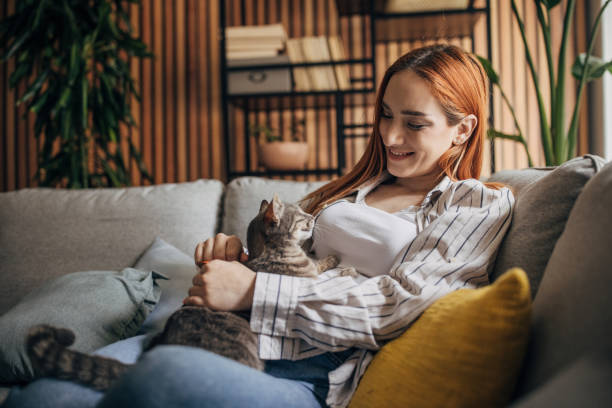 istock Young woman cuddling with cat at home 1511207703