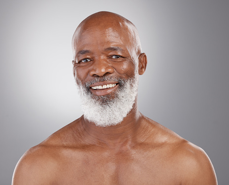 Senior, skincare and portrait of black man in studio for beauty, grooming and wellness on grey background. Face, smile and happy elderly male model relax and excited for body care, results and pamper