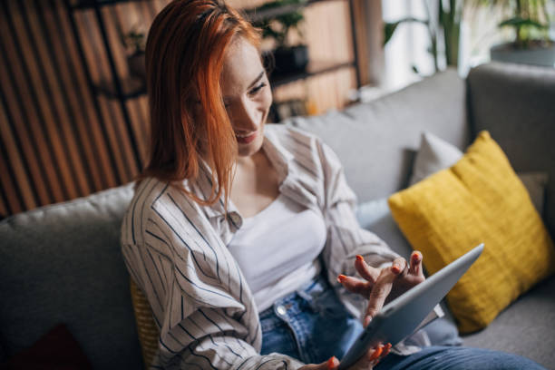 istock Redhead woman using digital table and relaxing at home 1511214897