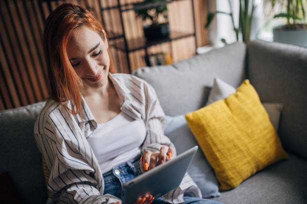 istock Redhead woman using digital table and relaxing at home 1511222947