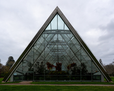 Step into the future with this innovative triangle shaped greenhouse. Its sleek design and vibrant green hues create a visually stunning and eco-friendly environment.