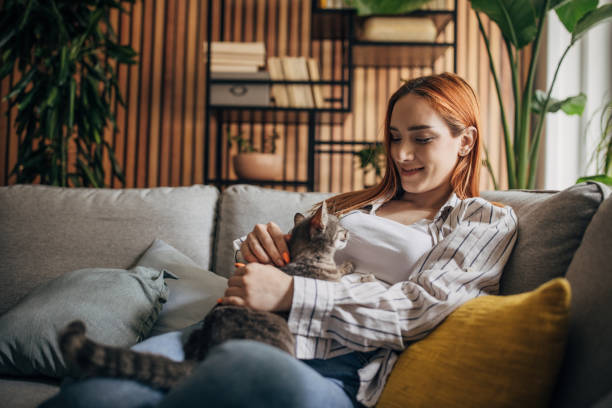 istock Young woman cuddling with cat at home 1511230768