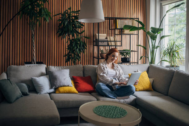 istock Redhead woman using laptop and relaxing at home 1511237220
