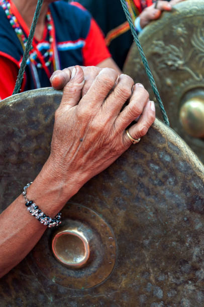 Hand holding a traditional gong Mature hand holding a traditional gong Sabah Malaysia kadazan people stock pictures, royalty-free photos & images