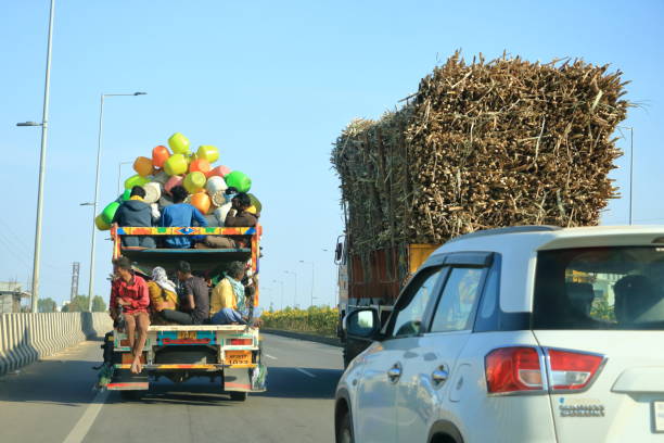 December 18 2022 - Karnataka in India: truck heavily overloaded with sugar cane is going to the factory