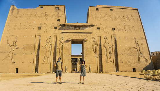 A tourist couple leaving the Edfu Temple near the Nile River in Aswan. Egypt, return of tourism in the coronavirus pandemic after 6 months stopped