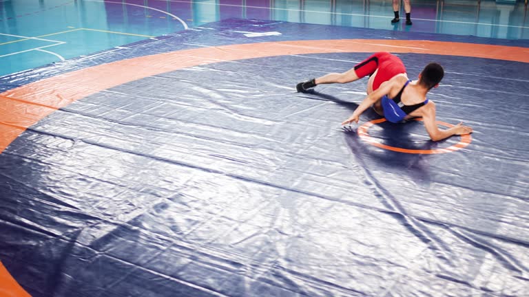 Singlet Showdown: Red vs. Blue Wrestlers in a Competitive Match