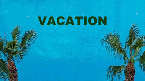 background image. Blue water, sea and two palm trees. Text, Vacation.