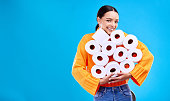 Toilet paper, happiness and woman portrait with mockup and home inventory stock. Isolated, blue background and studio with a young female holding tissue rolls with a happy smile and joy with mock up