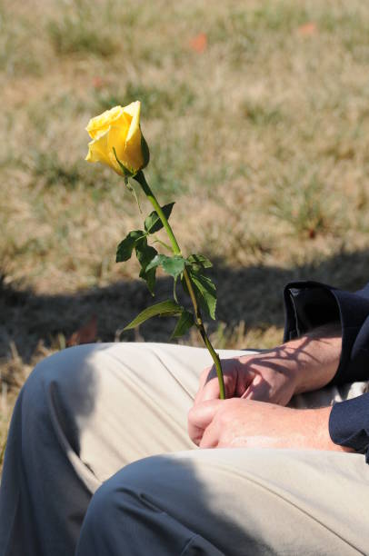 Mourner with a yellow rose