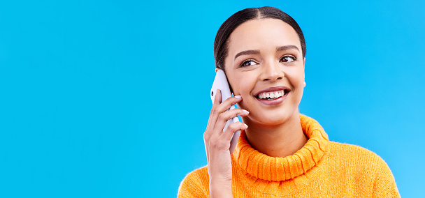 Happy woman, phone call and communication on mockup for social media, conversation or chat against a blue studio background. Female smiling on mobile smartphone in discussion or talking on copy space