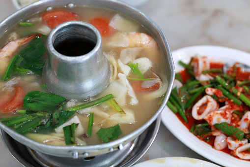 Tom Yum is a highly popular Thai dish that literally translates to 'hot and sour.' When prepared in a traditional Chinese hot pot, it creates a delightful and flavorful Asian festive meal.