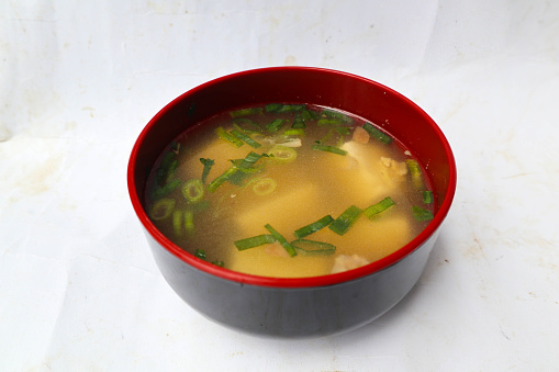 miso soup or Japanese miso soup in bowl on the table. Japanese cuisine in the form of soup with dashi ingredients, tofu, seafood, vegetables, and topped with miso to taste