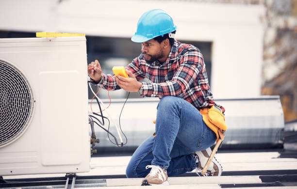 Air conditioner, cables and technician man ac repair, maintenance or working on electrical power generator. African person, electrician or contractor with electricity, heat pump check and engineering stock photo