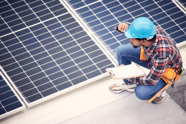 istock Solar panel, clipboard and engineering man with inspection, energy saving maintenance and sustainable power check. Contractor person, electrician or technician on checklist for photovoltaic generator 1511329830